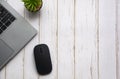 Top view of laptop, table plant and mouse on white wooden table with customizable space for text. Copy space Royalty Free Stock Photo