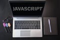 Top view of laptop with text Javascript. JavaScript inscription on laptop screen and keyboard. Learn programming language, Royalty Free Stock Photo