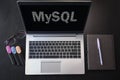 Top view of laptop with text MySQL. MySQL inscription on laptop screen and keyboard. Learn MySQL language, computer courses,