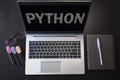 Top view of laptop with text python. Python inscription on laptop screen and keyboard. Learn python programming language, computer Royalty Free Stock Photo