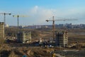 Top view of a large construction site with cranes and buildings houses concrete monolithic frame panel multi-storey Royalty Free Stock Photo