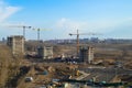 Top view of a large construction site with cranes and buildings houses concrete monolithic frame panel multi-storey Royalty Free Stock Photo