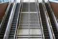 Top view of a large multi-level escalator and pedestrian staircase