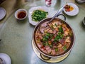 Top view of `Larouguo` or Spicy Smoked pork hotpot in chinese restaurant.