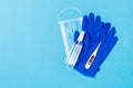 Top view of latex gloves, bottle of alcohol hand sanitizes, medical mask and digital thermometer on blue background. Antibacterial Royalty Free Stock Photo