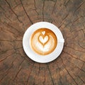 Top view latte art coffee on tree stump texture background Royalty Free Stock Photo