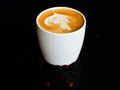 Top view of latte art ,on the dark wood table have many coffee beans