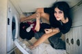 Top view, laundry cleaning and woman by washing machine in home getting ready to wash clothing. Spring cleaning, hygiene Royalty Free Stock Photo