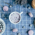 Top view of lavender macarons with spiced milk and frozen berries