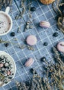 Top view of lavender macarons with spiced milk and frozen berries