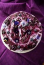 Top view of layered cake with blueberries and lilac