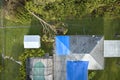 Top view of leaking house roof covered with protective tarp sheets against rain water leaks until replacement of asphalt Royalty Free Stock Photo