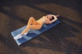 Top view. Leaning on the mat. Young woman in sportswear have fitness session outdoors