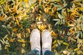 Top view of legs in boots on the autumn leaves. Autumn fall Royalty Free Stock Photo