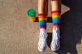 Top view of legs in bright colourful rainbow pride socks