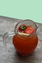 top view lemon tea (slime orange, rose apple, strawberry) put in a glass jug placed on a wooden floor, green wall background, Royalty Free Stock Photo