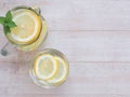 Top view lemons slice and water in glass, jar with mint leaves.