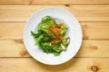 Top view of lenten salad with cucumber, spicy carrot, arugula and sesame