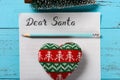 Letter paper with hand written Dear Santa and a pencil and a heart and a Christmas tree