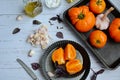 Top view of a light table with ripe yellow tomatoes on vintage bowls, basil leaves, garlic and olive oil Royalty Free Stock Photo