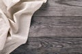 Top view of the light tablecloth on left side of wooden table