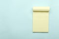 Top view of new blank notepad on the blue background.Empty space for text
