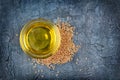 Top view of linseed oil in glass bowl and flax seeds Royalty Free Stock Photo