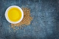 Top view of linseed oil in white bowl and flax seeds Royalty Free Stock Photo