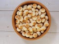 Top view of little ball cookies on wooden bowl on wooden background. Designed mouthpieces for children