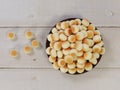 Top view of little ball cookies on wooden plate on wooden background. Designed mouthpieces for children Royalty Free Stock Photo