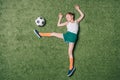 Top view of little boy pretending playing soccer on grass