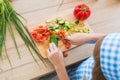 TOP VIEW: Little girl in cook clothes cuts a cucumber on a board on a kitchen Royalty Free Stock Photo