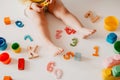 Top view little girl legs with numbers and letters. Study little kids concept