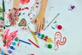 Top view Little girl with painted colorful watercolor hands, child sitting at the table and drawing, Royalty Free Stock Photo
