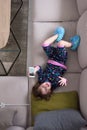 Top view of little girl using a smartphone on the sofa Royalty Free Stock Photo