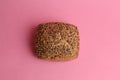 Top view of a loaf of brown bread with sesame seeds isolated on a pink background Royalty Free Stock Photo