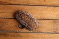 Top view of a loaf of brown bread on a wooden table under the lights Royalty Free Stock Photo