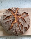 Top view of a loaf of coarse rye bread on the wooden board Royalty Free Stock Photo