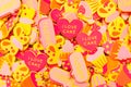 Top view of lots of candy-coloured foam stickers depicting hearts, butterflies and cupcakes. Summer or joy concept