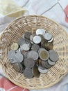 Top view, lots of Thailand& x27;s five and ten baht coin in basket, savings idea.