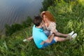 Top view of loving couple relaxing on grass and hugging. relationships and feelings concept. Couple on picnic hugging on grass Royalty Free Stock Photo