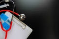 Top view low key conceptual of corona virus outbreak alert. Mini chalkboard, red stethoscope, medicine tablets and syringe on Royalty Free Stock Photo