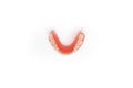 Top view of the lower denture on a white background. Dental prosthesis close-up. Dentures. Isolate on white background.