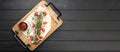 Top view of lula kebab served on a wooden cutting board on a black background, flat lay. Restaurant grill