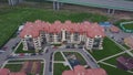 Top view of luxury suburban apartment complex. Clip. Aerial view apartment buildings complex and residential houses