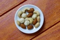 Top view of macadamia,cashew,almond and peanuts nuts in bowl on wooden background. Royalty Free Stock Photo