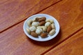 Top view of macadamia,cashew,almond and peanuts nuts in bowl on wooden background. Royalty Free Stock Photo