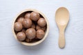 Top view macadamia in wooden bowl Royalty Free Stock Photo