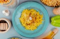 top view of macaroni pasta in plate with different macaronis as bucatini and others black pepper garlic pepper butter around on Royalty Free Stock Photo