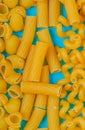 top view of macaronis as pipe-rigate ziti and fusilli on blue background